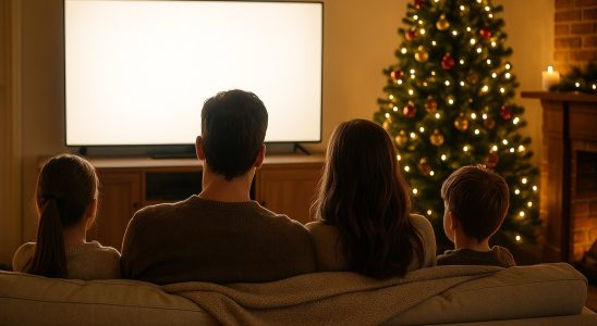 Best holiday movies to stream: family watching a movie by the Christmas tree